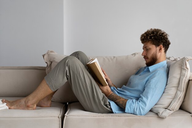 Free photo full shot man reading at home