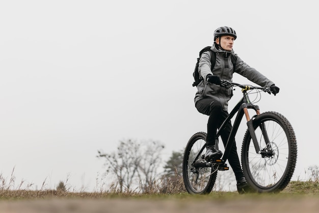 Full shot of man riding a bike