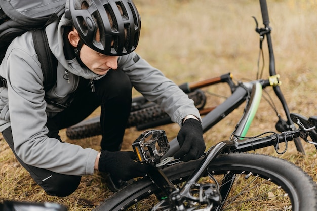 Free photo full shot of man riding a bike