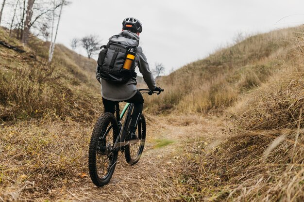 Full shot of man riding a bike