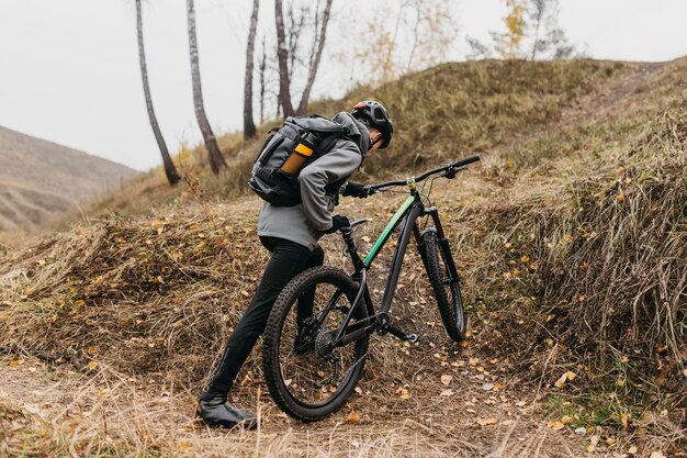 Full shot of man riding a bike