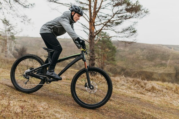 Full shot of man riding a bike