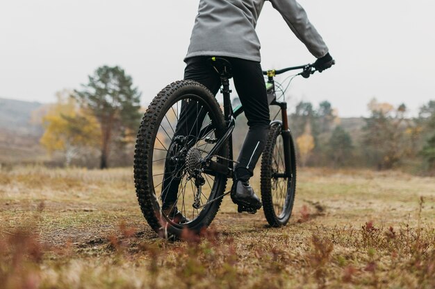 Full shot of man riding a bike