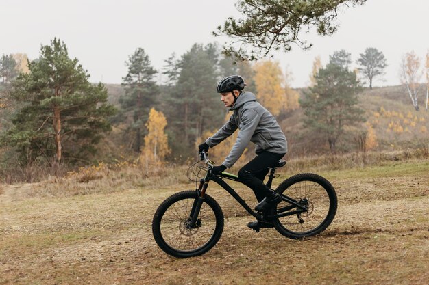 Full shot of man riding a bike