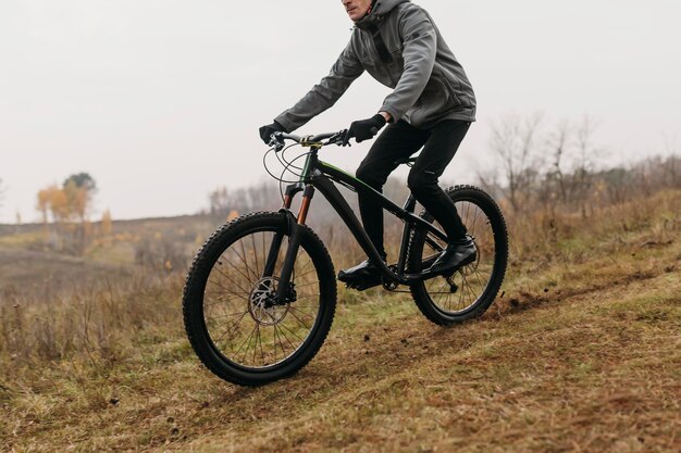 Full shot of man riding a bike