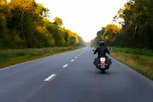 Free photo full shot man riding a motorbike