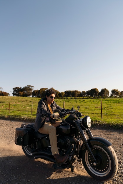 Free photo full shot man riding a motorbike