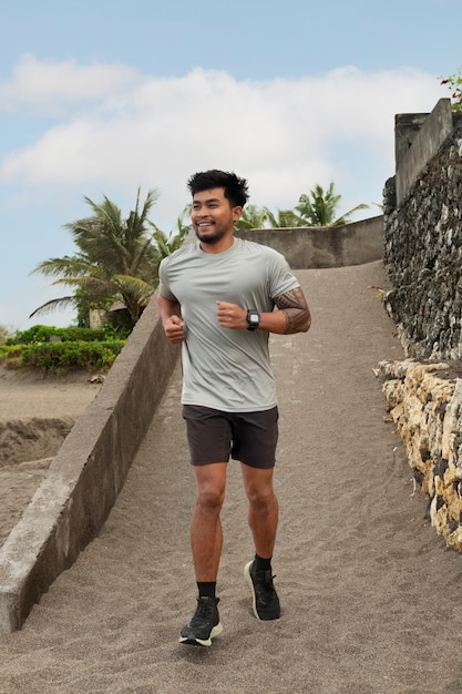 Full shot man running outdoors