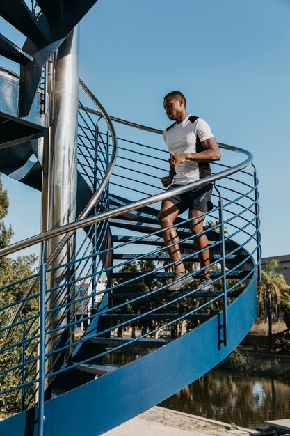 Full shot man running on stairs