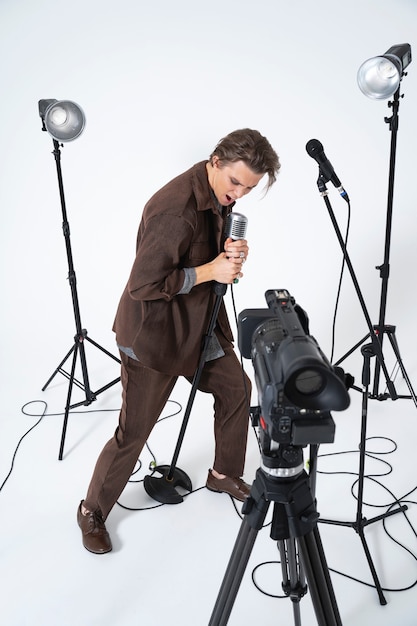 Full shot man singing in front of camera