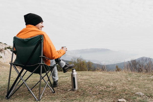 Full shot man sitting on chair