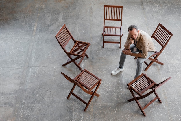 Free photo full shot man sitting on chair