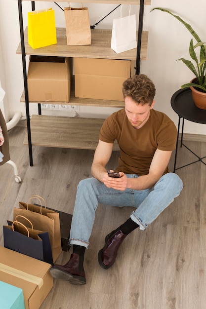 Full shot man sitting on floor