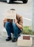 Free photo full shot man sitting outdoors