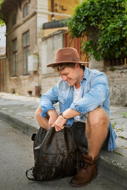 Full shot man sitting outdoors