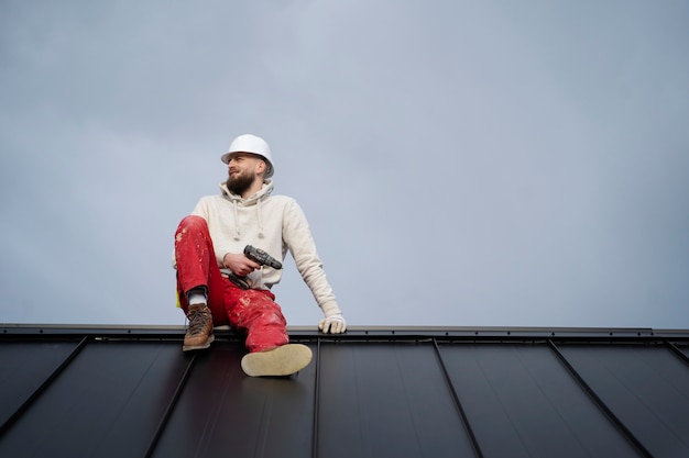 Full shot man sitting on roof