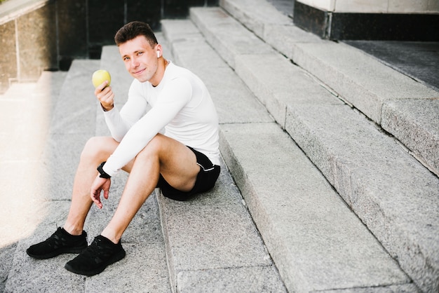 Full shot of man sitting on stairs