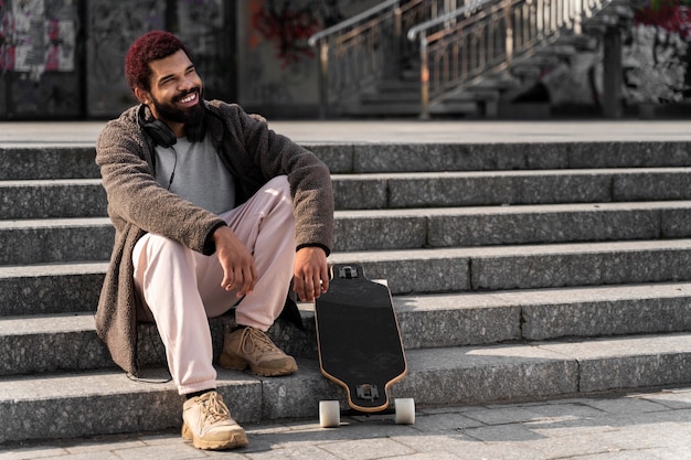 Full shot man sitting on stairs