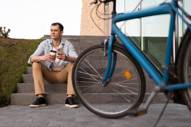 Full shot man sitting on stairs