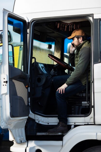 Full shot man sitting in truck