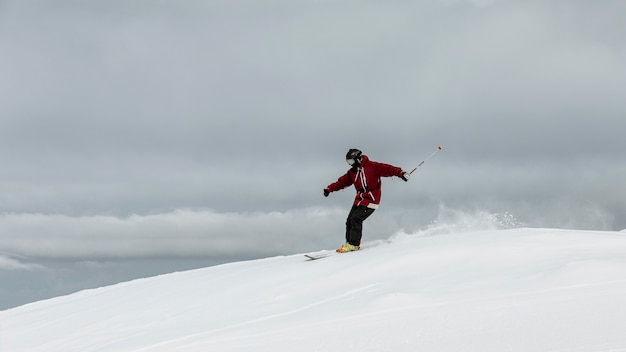 Full shot man skiing