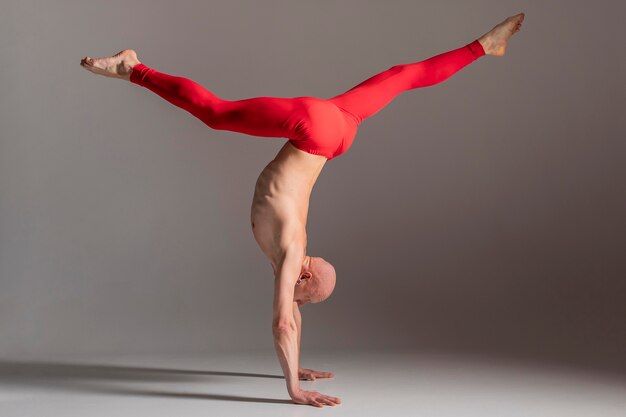 Full shot man standing on hands