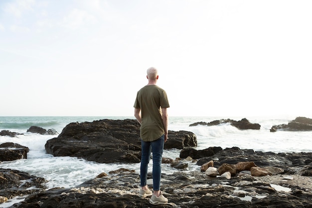 Full shot man standing on rocks