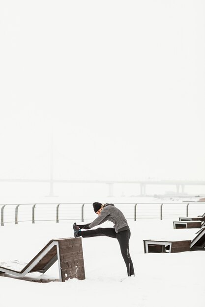 full shot man stretching leg
