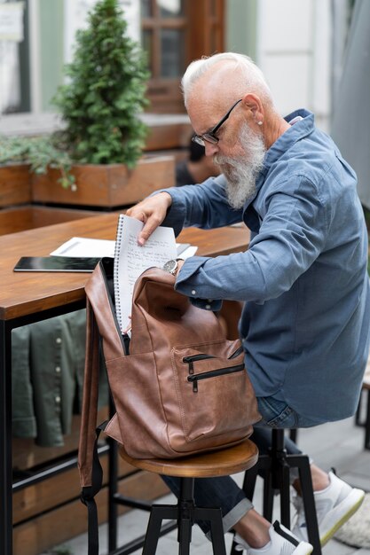 屋外で勉強しているフルショットの男