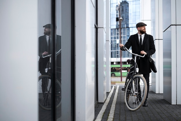 Full shot man in suit with bicycle