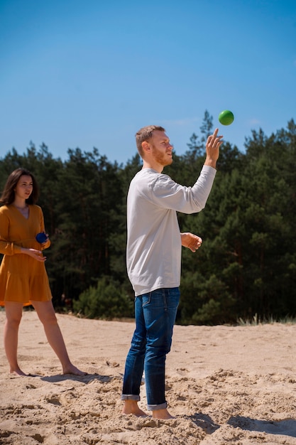 Full shot man throwing green ball