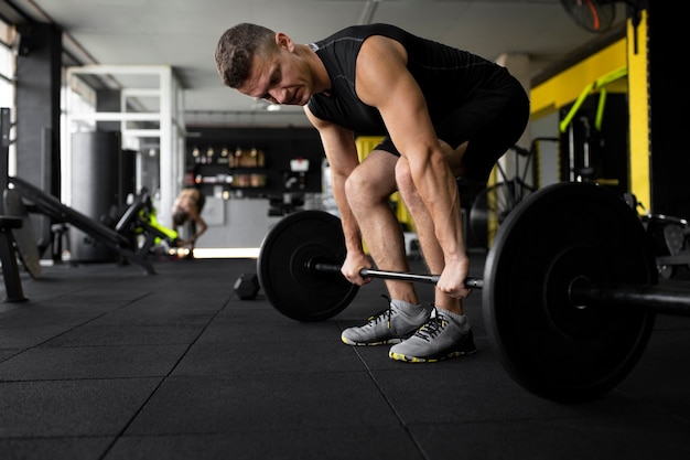 Full shot man training with dumbbell