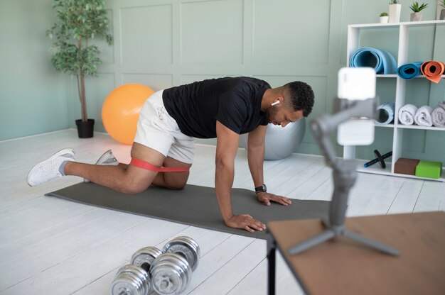 Full shot man training on yoga mat