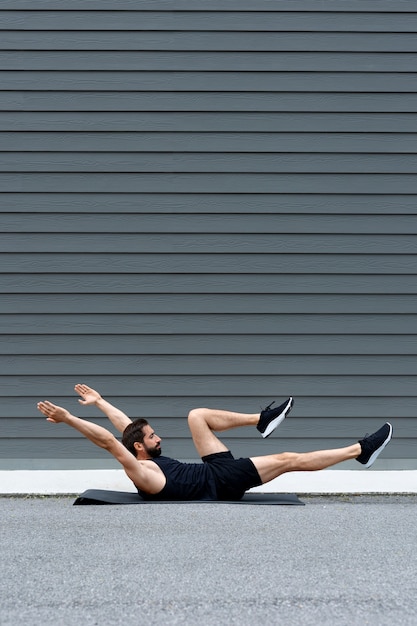 Full shot man training on yoga mat