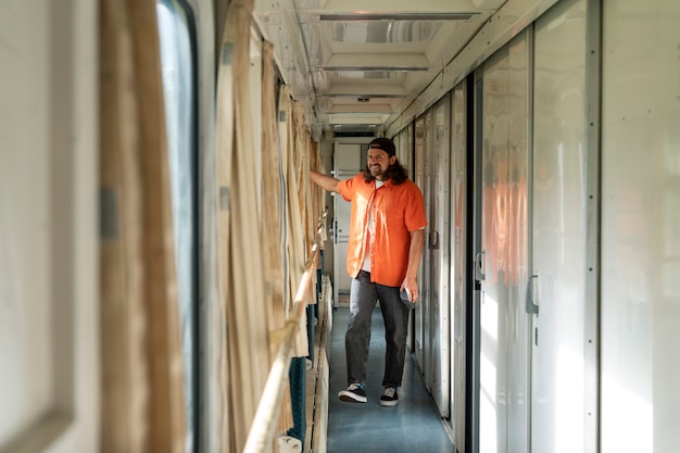 Free photo full shot man traveling by train