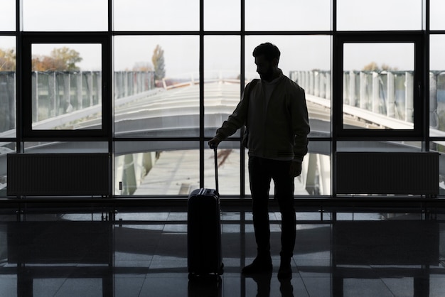 Full shot man traveling with baggage