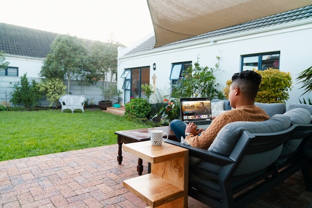 Free photo full shot man using laptop outdoors