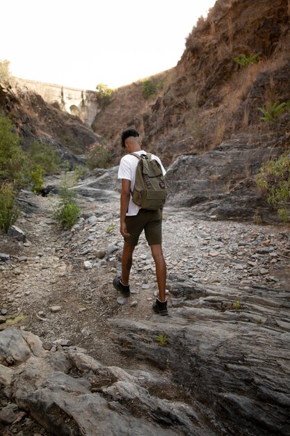 Full shot man walking with backpack