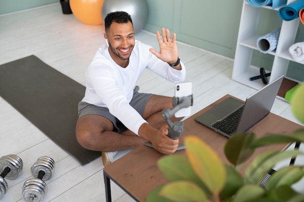 Full shot man waving at phone