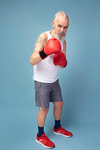 Full shot man wearing boxing gloves