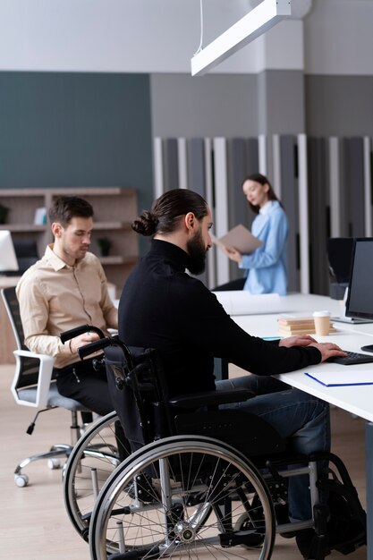 Full shot man in wheelchair working