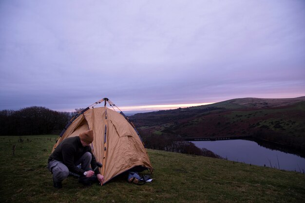 Full shot man winter camping