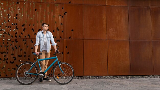 full shot man with bicycle