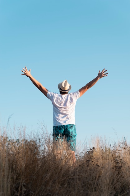 Free Photo full shot of a man with his arms in the air