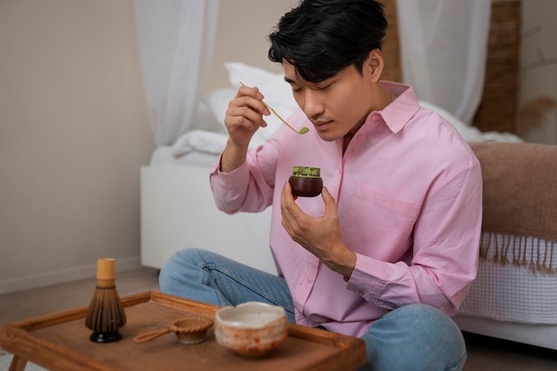 Free photo full shot man with matcha tea