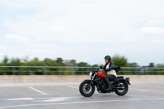 Full shot man with motorbike outdoors