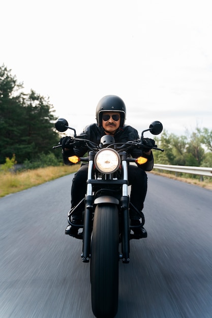 Full shot man with motorbike outdoors