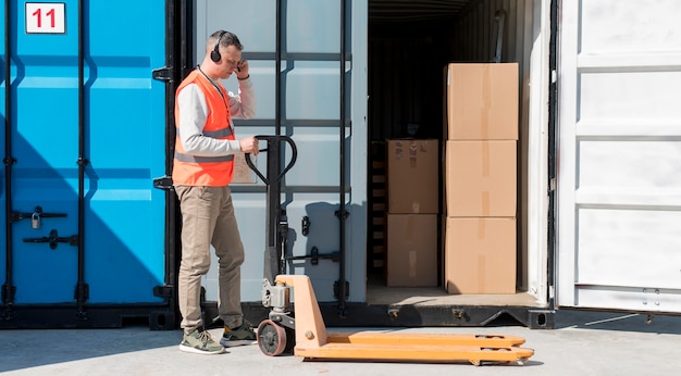 Full shot man with pallet truck