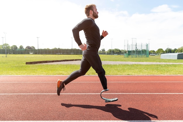 Full shot man with prosthetic leg running