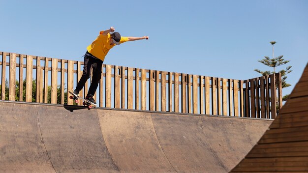 Full shot man with skateboard having fun